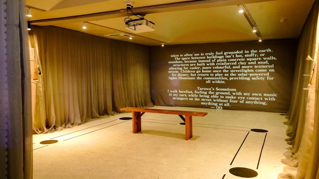 Sarauniya Ènè text-based projection describing Taruwa's Sensations across a curtained gallery wall at CCA Lagos