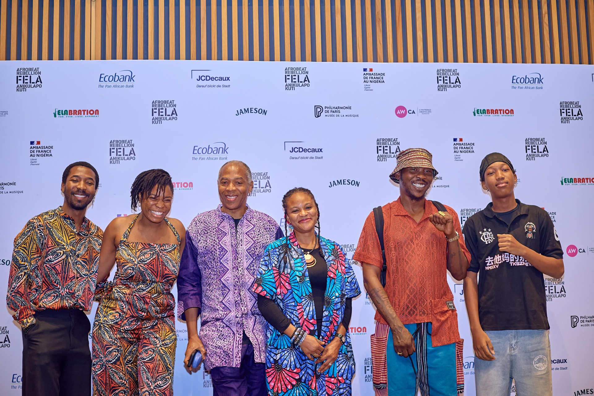 Guests posing at the Afrobeat Rebellion step-and-repeat wall in Lagos