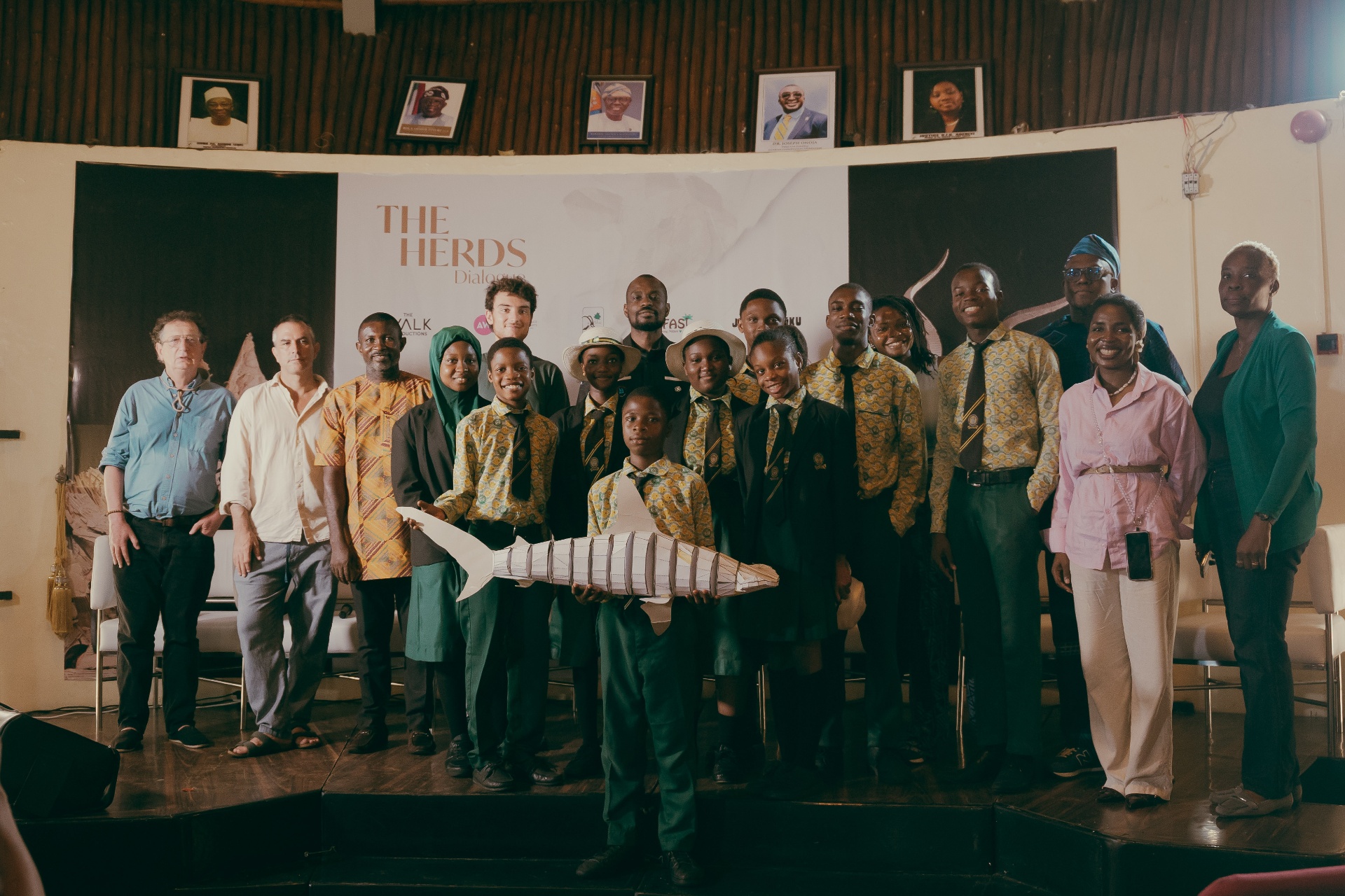 Group photo of The Herds Dialogue participants and students on stage