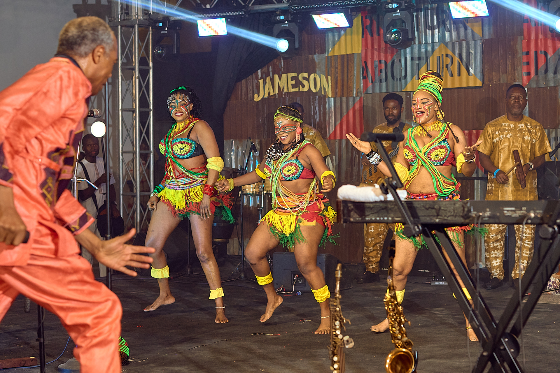 Femi Kuti performing alongside beaded dancers on the Jameson stage at Afrobeat Rebellion
