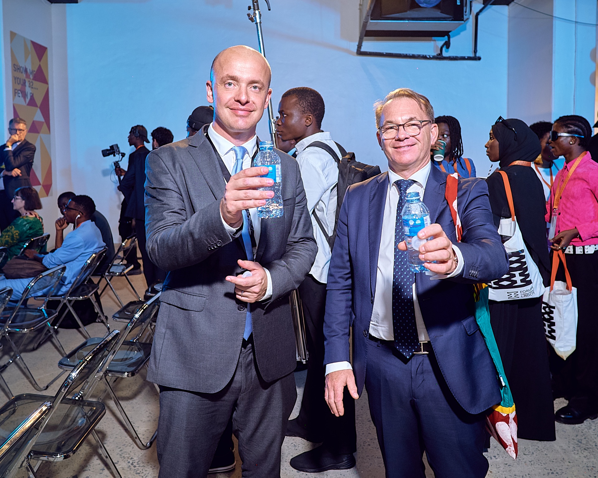 Guests raising water bottles ahead of the Afrobeat Rebellion public programme