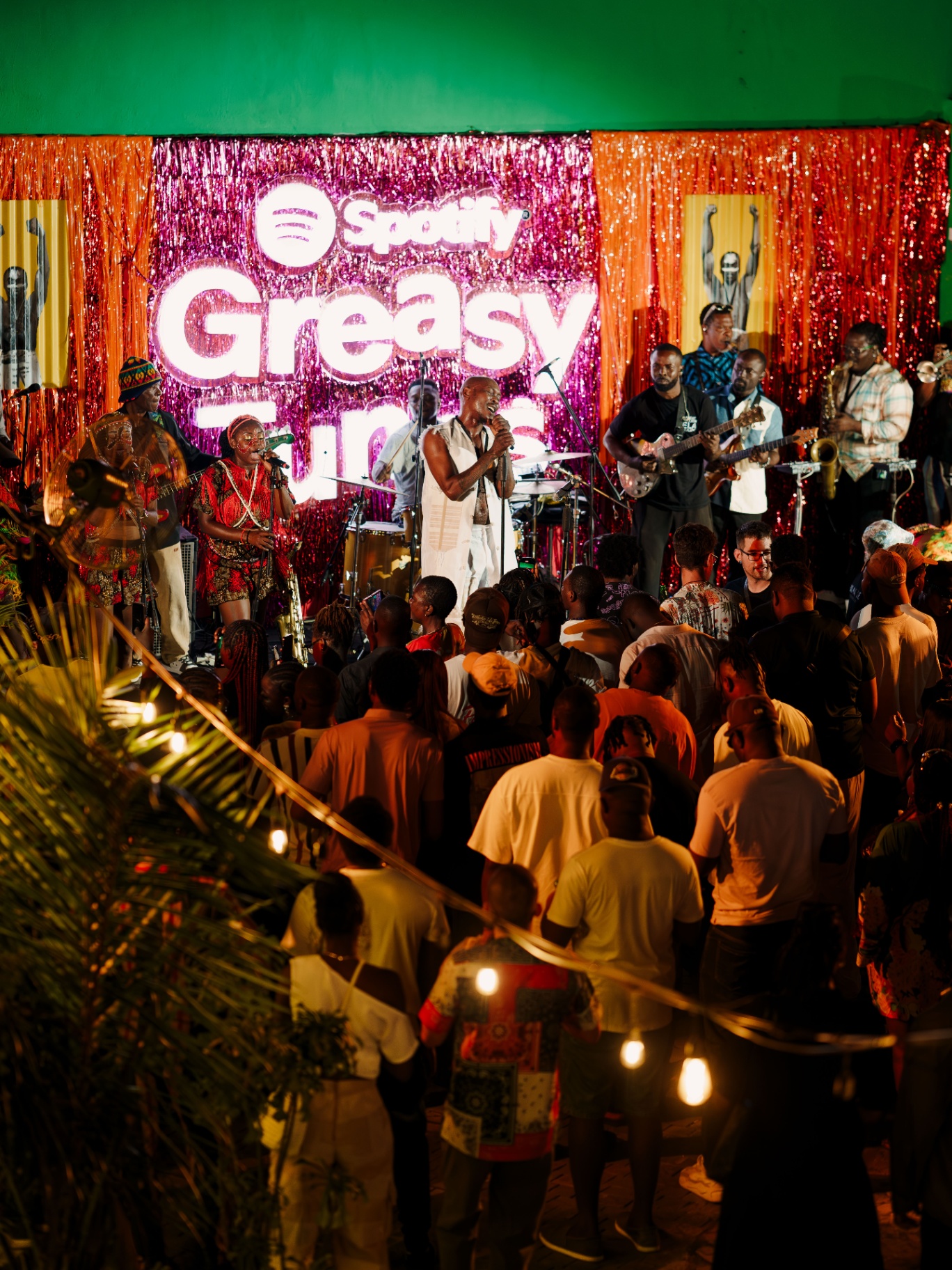 Live Afrobeat band performing under the Spotify Greasy Tunes stage backdrop in Lagos